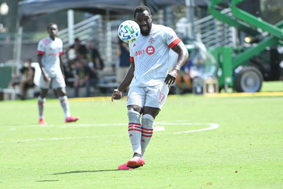 Jozy Altidore controlling the ball in a white Toronto FC kit